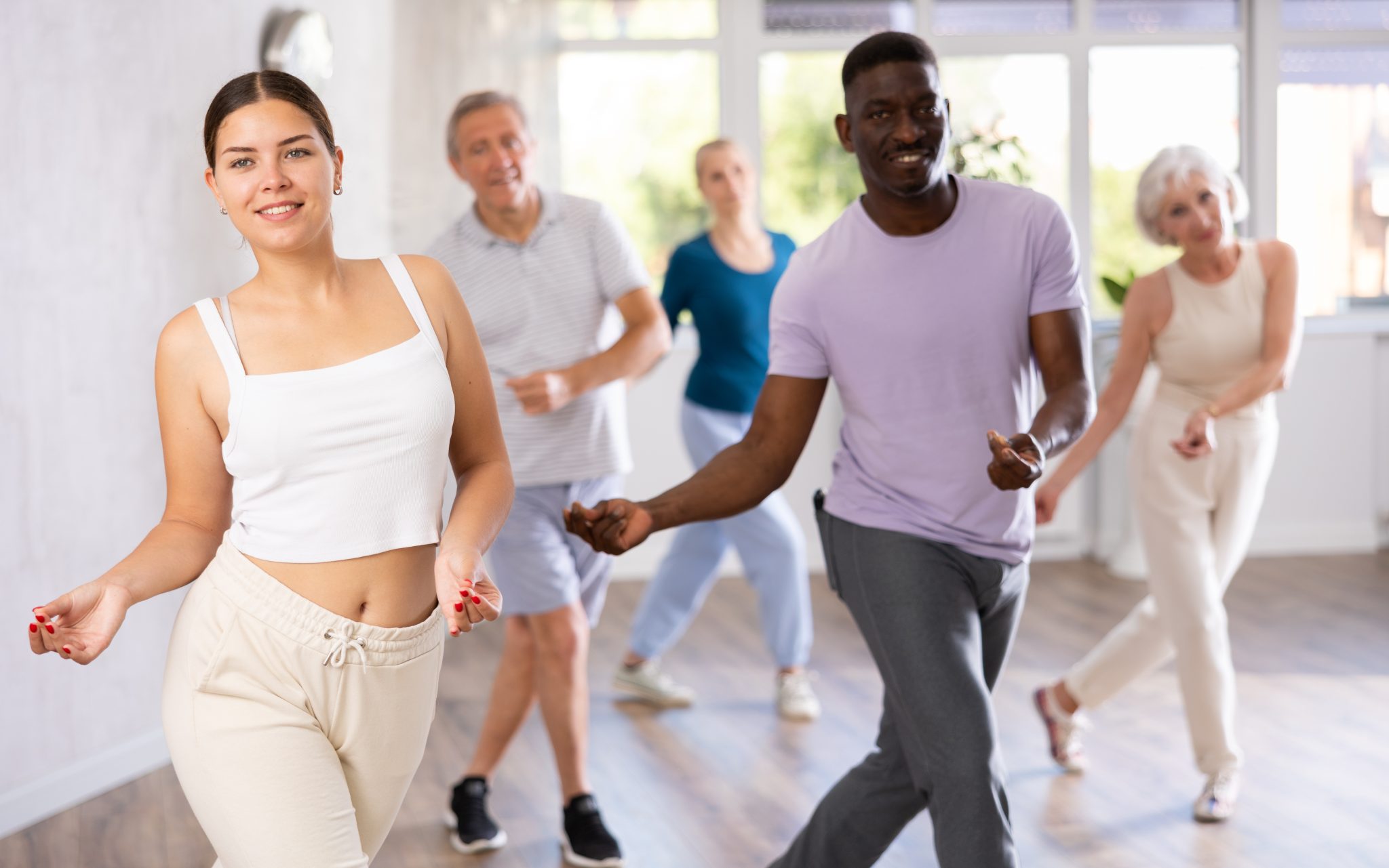 young girl learning modern dynamic dances during group class